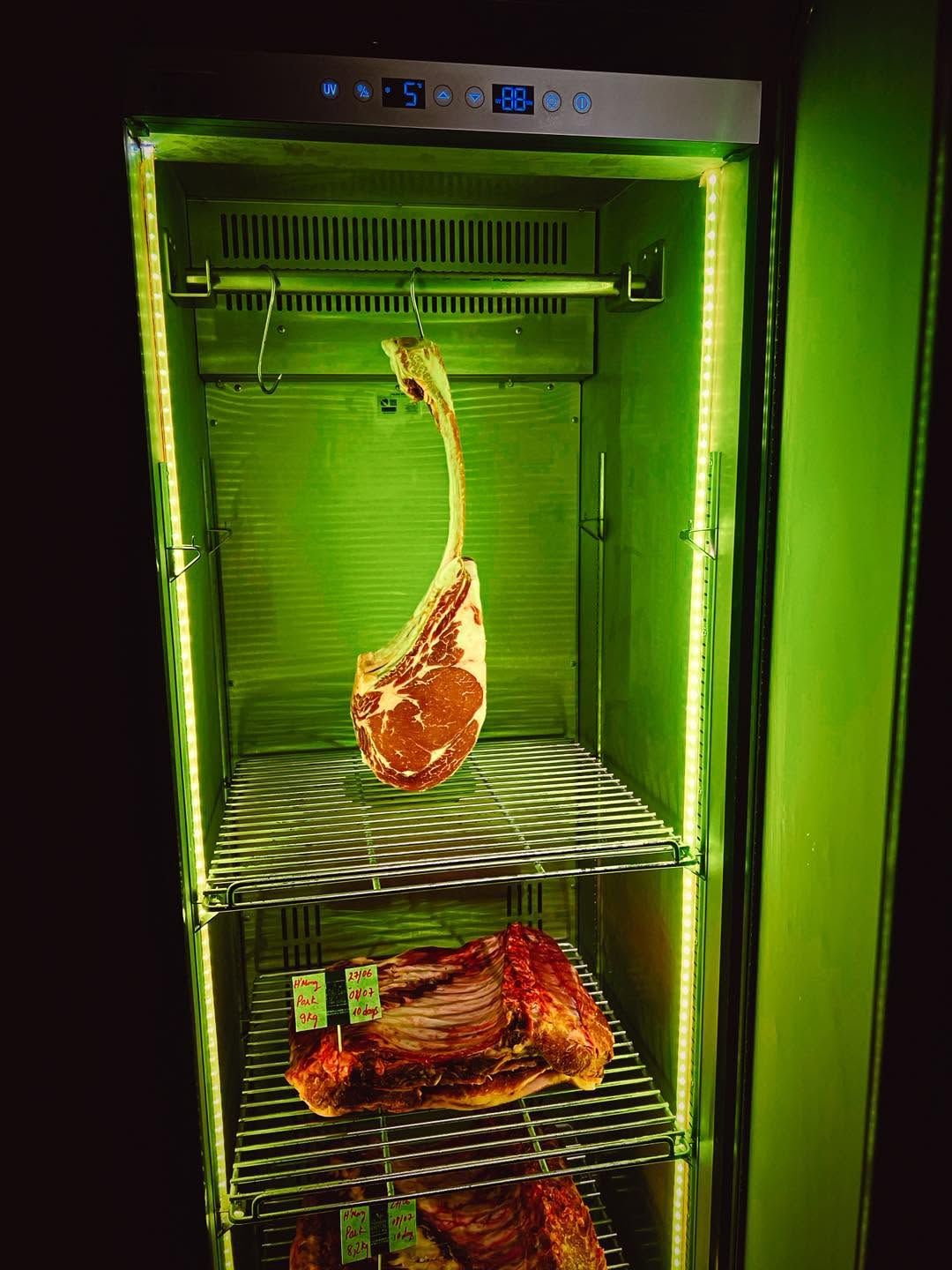 A tomahawk hanging in the dry-ageing cabinet