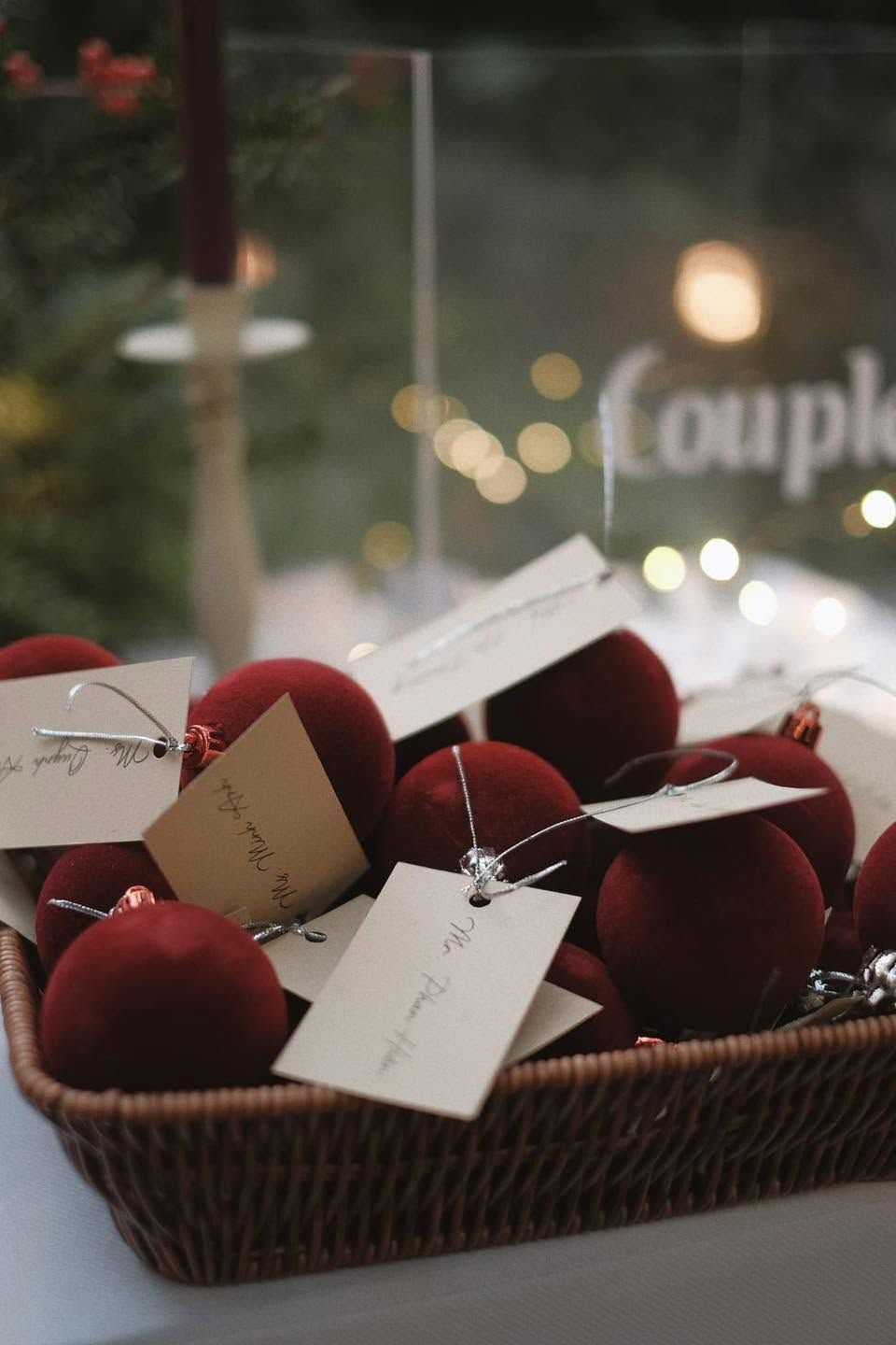 Red velvet baubles with handwritten name tags for Christmas dinner