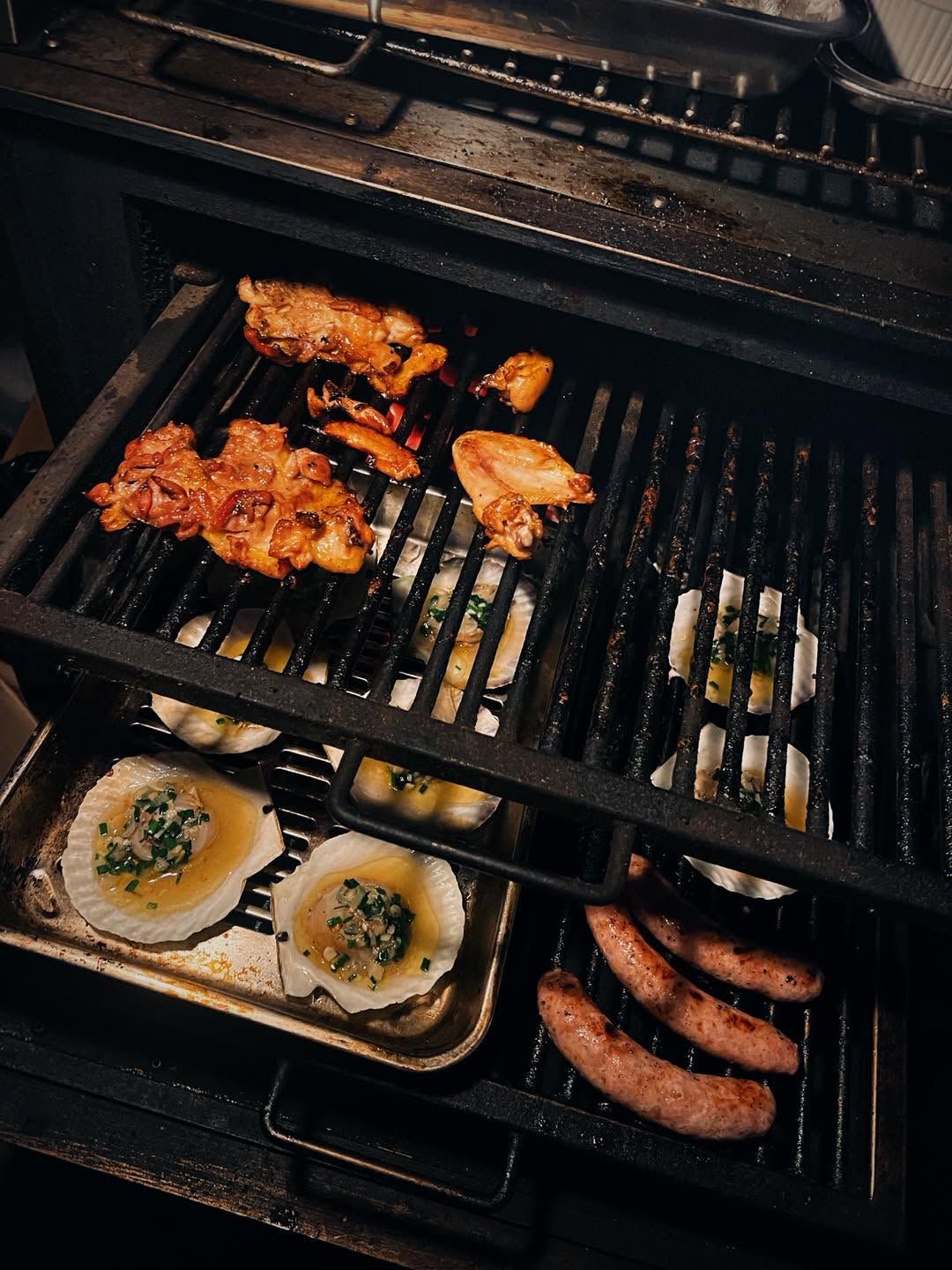 Scallops, chicken and sausages on the grill